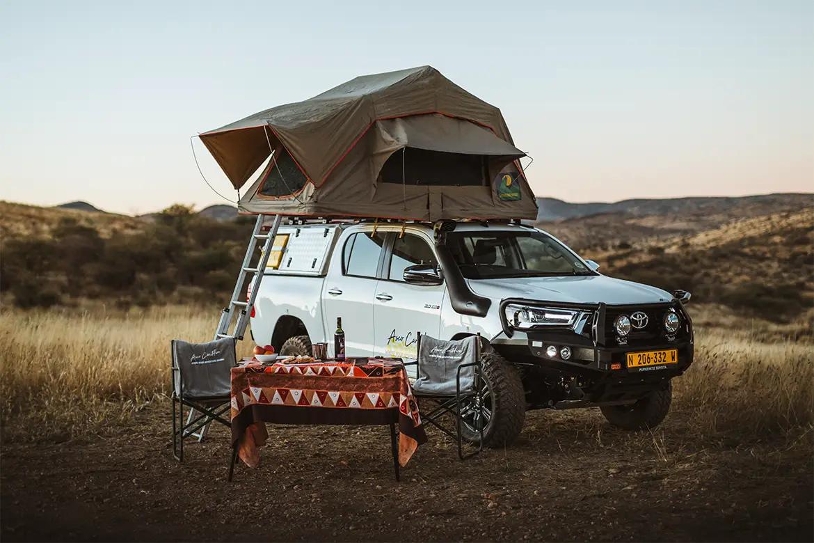 4x4 Self-Drive Rental Car With an open Rooftoptent Camping Gear