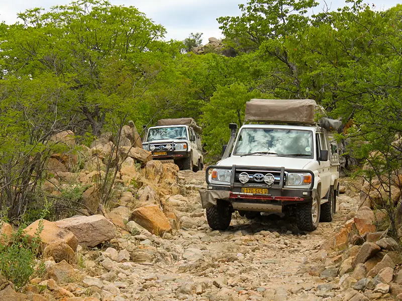 Two 4×4 Cars On Rough Namibian terrain Two 4x4 Cars On Rough Namibian terrain