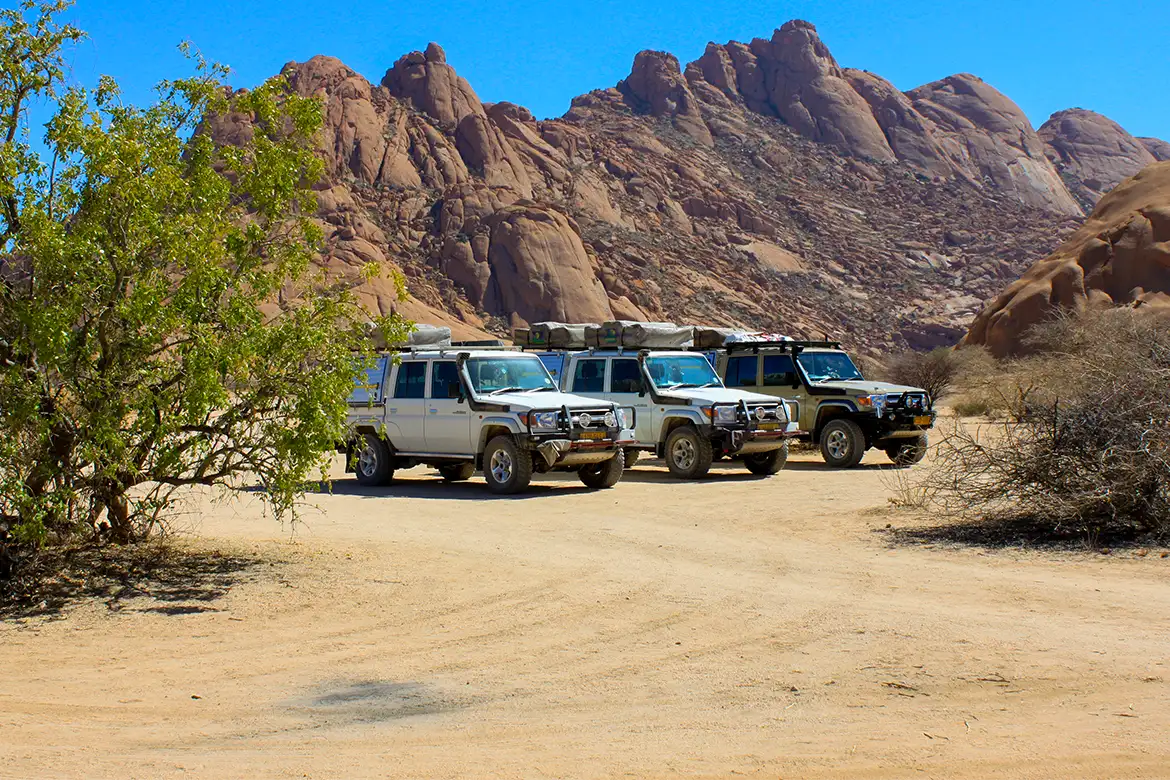 Three Guided 4x4 safari vehicles standing, Namibia
